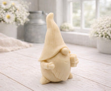 Load image into Gallery viewer, A cream-coloured handmade vegan soap sculpted as a tall, whimsical gnome (gonk) with a pointed hat and long beard, featuring a natural twine hanging rope at the top and displayed in a bright farmhouse setting.
