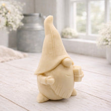 Load image into Gallery viewer, A cream-coloured handmade vegan soap sculpted as a tall, whimsical gnome (gonk) with a pointed hat and long beard, featuring a natural twine hanging rope at the top and displayed in a bright farmhouse setting.