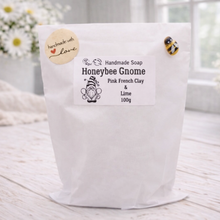Load image into Gallery viewer, Handmade soap packaging with 'Honeybee Gnome' branding on a light wooden surface.