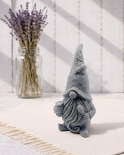 Load image into Gallery viewer, A handmade vegan soap in the shape of a gnome with a long beard, wearing a honeycomb-patterned hat with a bee, holding a honey pot and dipper.