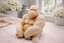 Load image into Gallery viewer, A highly detailed handmade vegan soap in a natural stone-grey colour, sculpted in the shape of a sitting gorilla with realistic fur and muscle textures, displayed on a light wooden surface.