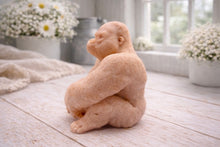 Load image into Gallery viewer, A highly detailed handmade vegan soap in a natural colour, sculpted in the shape of a sitting gorilla with realistic fur and muscle textures, displayed on a light wooden surface. Gift boxed.