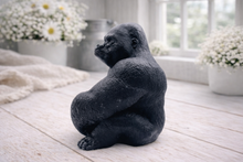 Load image into Gallery viewer, A highly detailed handmade vegan soap in a natural colour, sculpted in the shape of a sitting gorilla with realistic fur and muscle textures, displayed on a light wooden surface. Gift boxed.