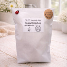 Load image into Gallery viewer, Happy Hedgehog handmade soap package on a wooden surface with a blurred background