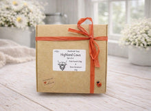 Load image into Gallery viewer, Box of Highland Cows handmade soap with a decorative ribbon on a wooden surface.