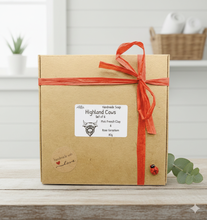 Load image into Gallery viewer, Gift box with a red ribbon on a wooden surface