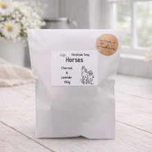 Load image into Gallery viewer, Handmade soap package labeled 'Horses' with charcoal and lavender scent on a wooden surface.