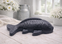 Load image into Gallery viewer, Handmade vegan soap sculpted in the shape of a koi carp fish with detailed scales and fins, resting on a light timber surface with a soft floral background.