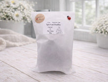 Load image into Gallery viewer, White bag labeled 'Spiritual Buddha' on a light wooden surface with a blurred background