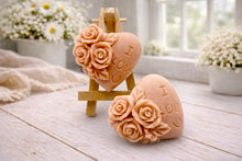 Load image into Gallery viewer, A handmade vegan soap gift set, featuring a central heart-shaped relief surrounded by a border of intricate rose flowers and delicate foliage, displayed on a small wooden easel.