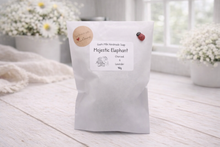 Load image into Gallery viewer, White product packaging with a label on a light wooden surface, surrounded by decorative elements.