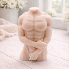 Load image into Gallery viewer, A 3D handmade vegan soap sculpted into a detailed male torso with defined chest and abdominal muscles, finished in a soft tone and displayed in a bright farmhouse setting.