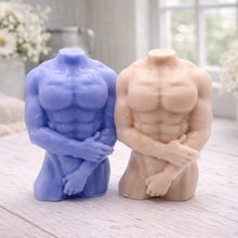 Load image into Gallery viewer, A 3D handmade vegan soap sculpted into a detailed male torso with defined chest and abdominal muscles, finished in a soft tone and displayed in a bright farmhouse setting.