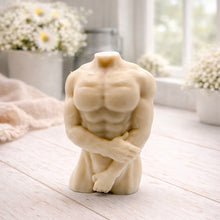 Load image into Gallery viewer, A 3D handmade vegan soap sculpted into a detailed male torso with defined chest and abdominal muscles, finished in a soft tone and displayed in a bright farmhouse setting.