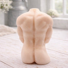 Load image into Gallery viewer, A 3D handmade vegan soap sculpted into a detailed male torso with defined chest and abdominal muscles, finished in a soft tone and displayed in a bright farmhouse setting.