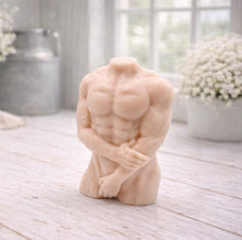 Load image into Gallery viewer, A 3D handmade vegan soap sculpted into a detailed male torso with defined chest and abdominal muscles, finished in a soft tone and displayed in a bright farmhouse setting.