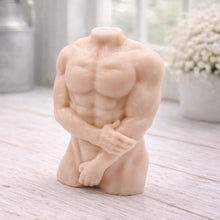 Load image into Gallery viewer, A 3D handmade vegan soap sculpted into a detailed male torso with defined chest and abdominal muscles, finished in a soft tone and displayed in a bright farmhouse setting.