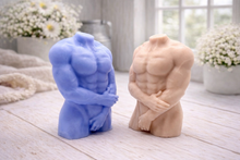 Load image into Gallery viewer, A 3D handmade vegan soap sculpted into a detailed male torso with defined chest and abdominal muscles, finished in a soft tone and displayed in a bright farmhouse setting.
