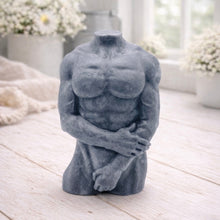 Load image into Gallery viewer, A 3D handmade vegan soap sculpted into a detailed male torso with defined chest and abdominal muscles, finished in a soft tone and displayed in a bright farmhouse setting.