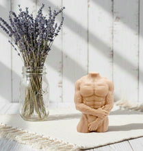 Load image into Gallery viewer, A highly detailed handmade vegan soap in the shape of a muscular male torso, featuring a detailed sculptural design, displayed against a whimsical background for a sophisticated farmhouse decor touch.