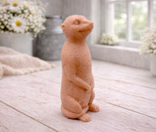 Load image into Gallery viewer, A highly detailed handmade vegan soap, sculpted in the shape of a realistic meerkat standing upright in its iconic sentinel pose, featuring textured fur and a curious facial expression, displayed on a light wooden surface.