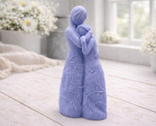 Load image into Gallery viewer, A 3D handmade vegan soap, sculpted as a mother and daughter in a tender standing embrace, featuring an intricate embossed floral and vine pattern on their dresses.
