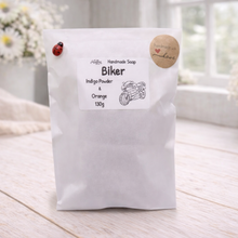 Load image into Gallery viewer, White soap bag with 'Biker' with a label on a light wooden surface.
