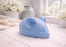 Load image into Gallery viewer, A 3D handmade vegan soap sculpted into the shape of a cute resting mouse with large rounded ears and a delicate snout, displayed on a light wooden surface in a bright farmhouse setting