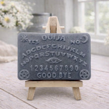 Load image into Gallery viewer, Ouija board soap on a stand with a wooden background