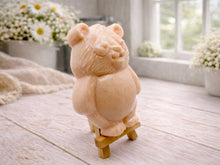 Load image into Gallery viewer, Handmade vegan soap sculpted in the shape of a round, sitting panda bear with detailed fur textures and a friendly expression, displayed on a small wooden easel.