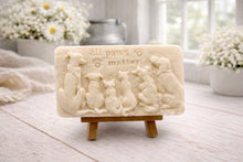 Load image into Gallery viewer, A rectangular handmade vegan soap bar gift, featuring a detailed relief carving of several dogs and a cat sitting together, with the words "all paws matter" and two paw prints embossed at the top, displayed on a wooden easel. Made in Blackpool.