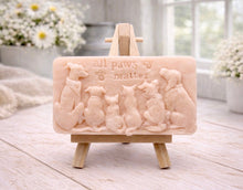 Load image into Gallery viewer, A rectangular handmade vegan soap bar gift, featuring a detailed relief carving of several dogs and a cat sitting together, with the words "all paws matter" and two paw prints embossed at the top, displayed on a wooden easel. Made in Blackpool.