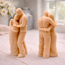 Load image into Gallery viewer, A 3D handmade vegan soap in a warm cream tone, sculpted into a standing figure of a pregnant couple; the partner stands behind the expectant mother, tenderly cradling her baby bump, displayed on a light wooden surface in a bright farmhouse setting.