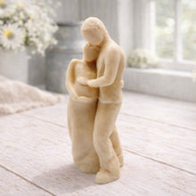 Load image into Gallery viewer, A 3D handmade vegan soap in a warm cream tone, sculpted into a standing figure of a pregnant couple; the partner stands behind the expectant mother, tenderly cradling her baby bump, displayed on a light wooden surface in a bright farmhouse setting.