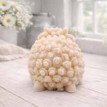 Load image into Gallery viewer, A highly detailed handmade vegan soap sculpted in the shape of a sturdy ram with a thick coat of tight, curly wool and large, elegant curved horns, displayed on a light wooden surface in a bright farmhouse setting.