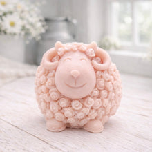 Load image into Gallery viewer, A highly detailed handmade vegan soap sculpted in the shape of a sturdy ram with a thick coat of tight, curly wool and large, elegant curved horns, displayed on a light wooden surface in a bright farmhouse setting.