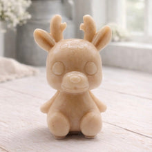 Load image into Gallery viewer, A 3D handmade vegan soap crafted into a cute, sitting baby reindeer with small antlers, rounded features, and a sweet expression, set against a bright farmhouse window.
