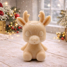 Load image into Gallery viewer, A 3D handmade vegan soap crafted into a cute, sitting baby reindeer with small antlers, rounded features, and a sweet expression, set against a bright farmhouse window.