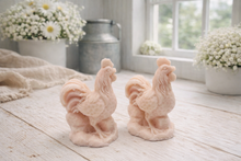 Load image into Gallery viewer, Two handmade vegan soaps sculpted in the shape of proud roosters (cockerels) with detailed feathers, combs, and curved tail feathers, standing on a rustic base, in a natural colour. Gift boxed