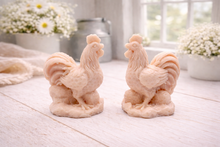 Load image into Gallery viewer, Two handmade vegan soaps sculpted in the shape of proud roosters (cockerels) with detailed feathers, combs, and curved tail feathers, standing on a rustic base, in a natural colour. Gift boxed