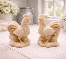 Load image into Gallery viewer, Two handmade vegan soaps sculpted in the shape of proud roosters (cockerels) with detailed feathers, combs, and curved tail feathers, standing on a rustic base, in a natural colour. Gift boxed