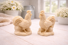 Load image into Gallery viewer, Two handmade vegan soaps sculpted in the shape of proud roosters (cockerels) with detailed feathers, combs, and curved tail feathers, standing on a rustic base, in a natural colour. Gift boxed