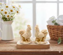 Load image into Gallery viewer, Two handmade vegan soaps sculpted in the shape of proud roosters (cockerels) with detailed feathers, combs, and curved tail feathers, standing on a rustic base, in a natural colour. Gift boxed