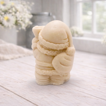 Load image into Gallery viewer, A highly detailed 3D handmade vegan soap featuring a Father Christmas carrying a large sack of gifts over his shoulder and holding a bell, featuring an intricate curly beard and fur-trimmed suit, set against a festive holiday background.