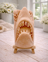 Load image into Gallery viewer, A 3D handmade vegan soap sculpted into a realistic great white shark head with its jaws wide open to reveal multiple rows of sharp teeth, displayed on a miniature wooden easel in a bright farmhouse setting.