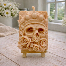 Load image into Gallery viewer, handmade vegan soap gift featuring a detailed relief of a skull wearing a crown, surrounded by a border of roses, displayed on a small wooden easel.
