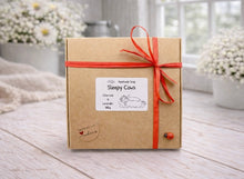 Load image into Gallery viewer, Box of 'Sleepy Cows' handmade soap with a red ribbon on a wooden surface.