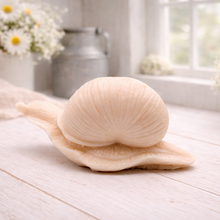 Load image into Gallery viewer, A highly detailed handmade vegan soap gift, sculpted in the shape of a realistic snail with a prominent spiralled shell and a textured, leathery body, displayed on a light wooden surface. Handmade in Blackpool.