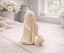 Load image into Gallery viewer, Decorative vegan soap figure of a ghost with a dog on a leash in a bright room with flowers.