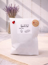 Load image into Gallery viewer, White bag labeled 'Sports Car' with a small car illustration on a light wooden surface.